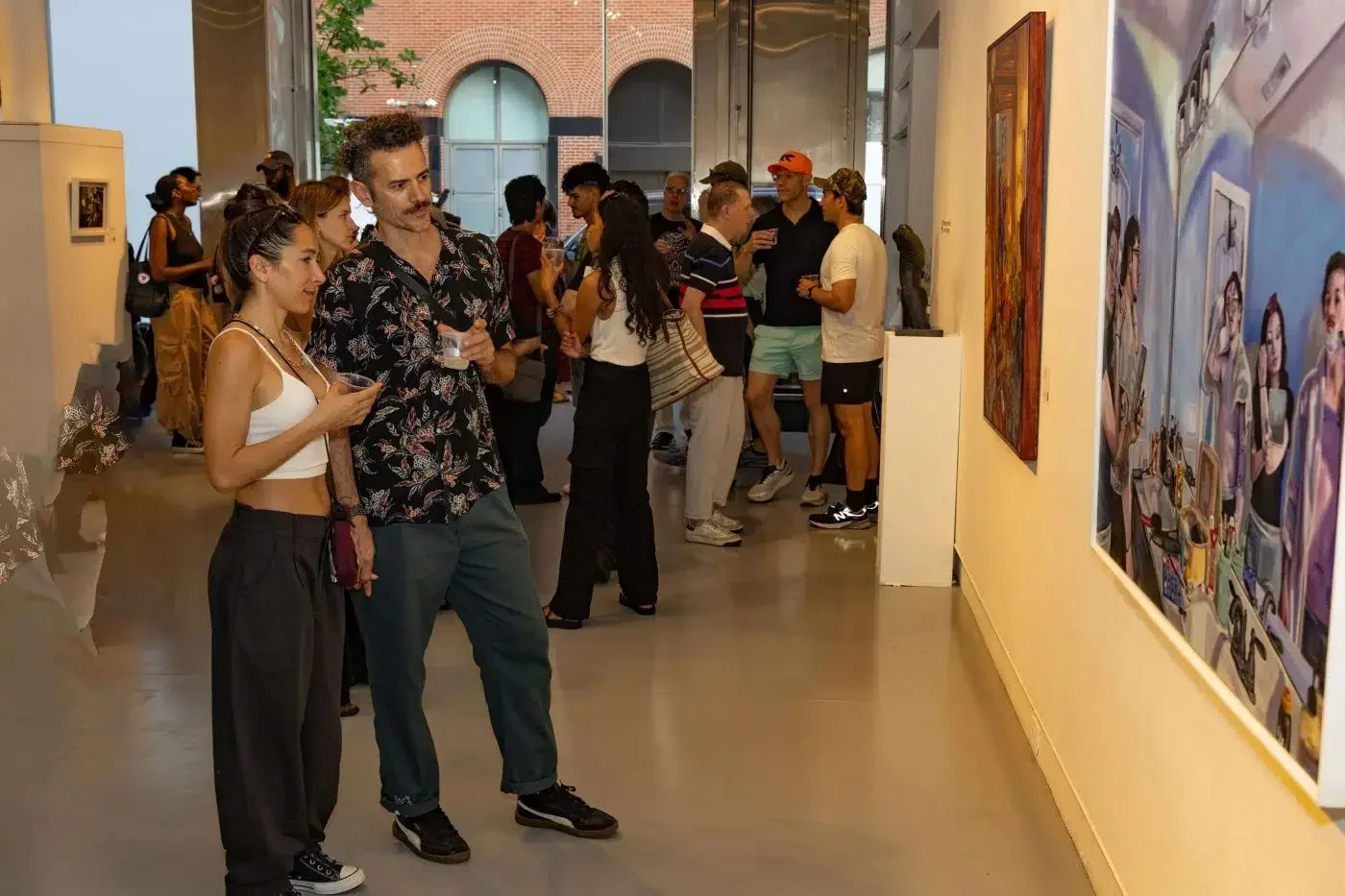 Visitors viewing artwork at an Agora Gallery opening reception in Chelsea, New York